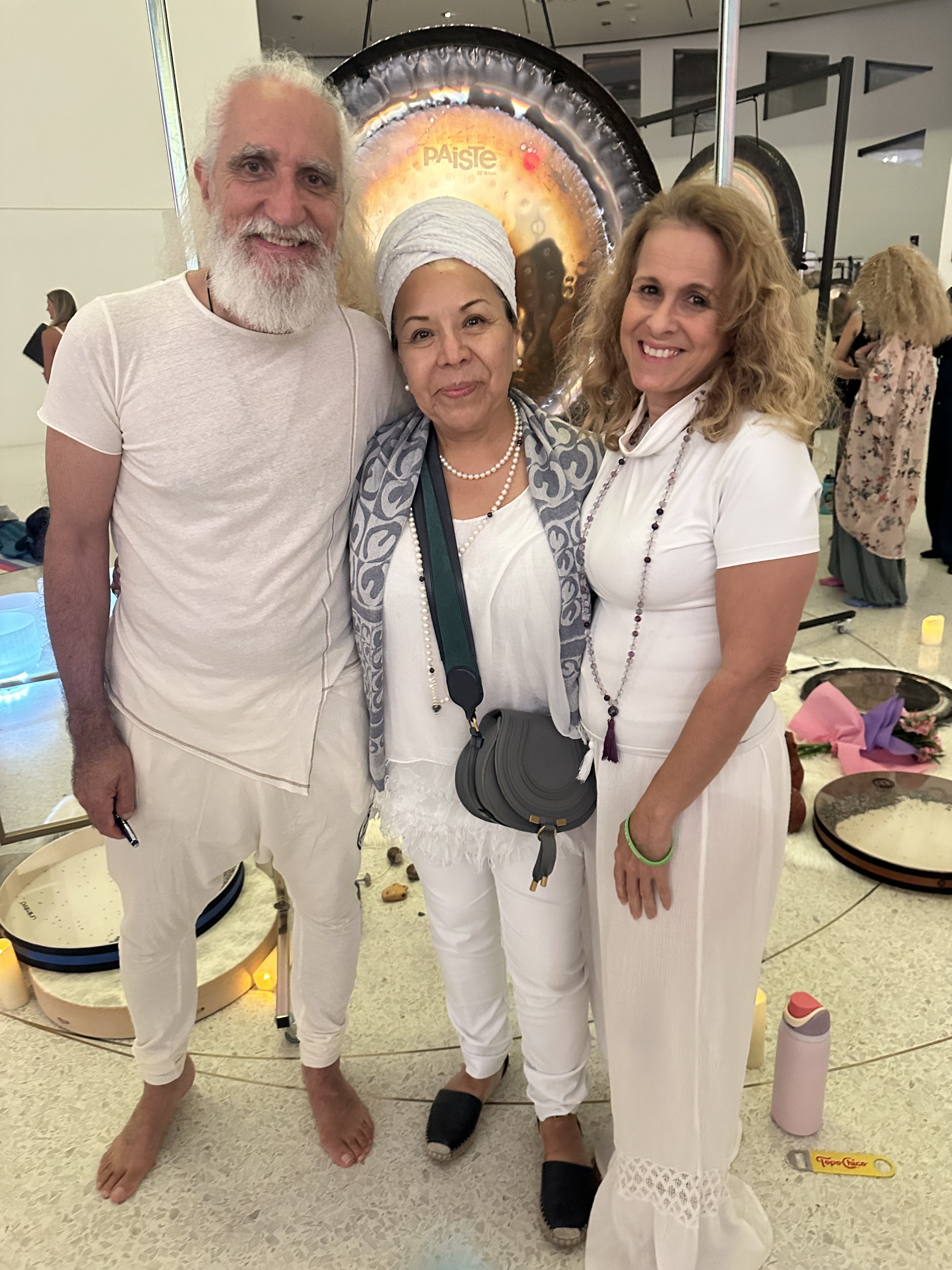 Diana with teachers Vikrampal Singh and Jap Hari Kaur in white in front of a Paiste gong